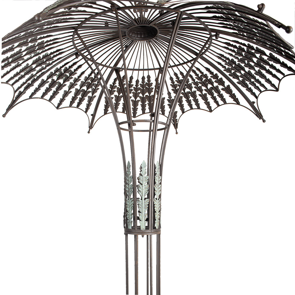 Round romantic garden bench with trellis obelisk and umbrella